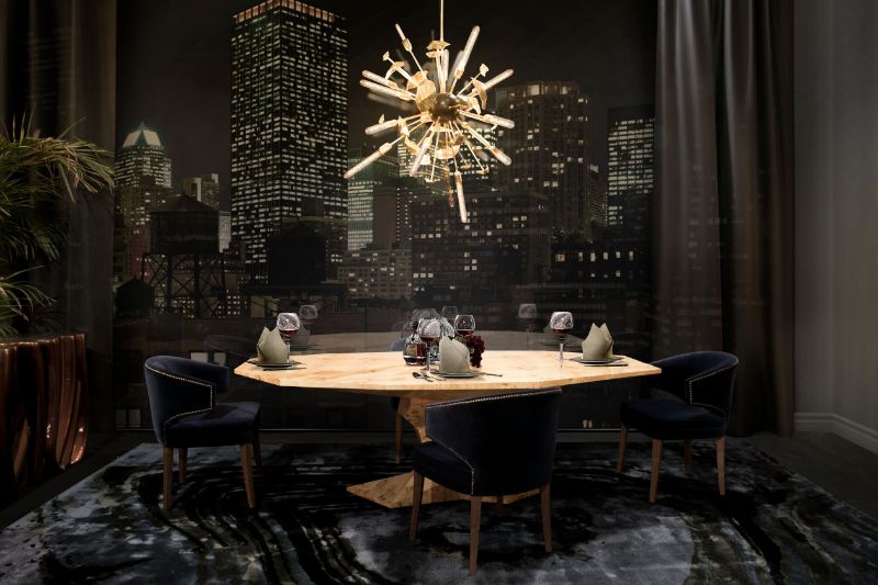 modern dining room with agatha rug, dark blue dining chairs and supernova hanging lights