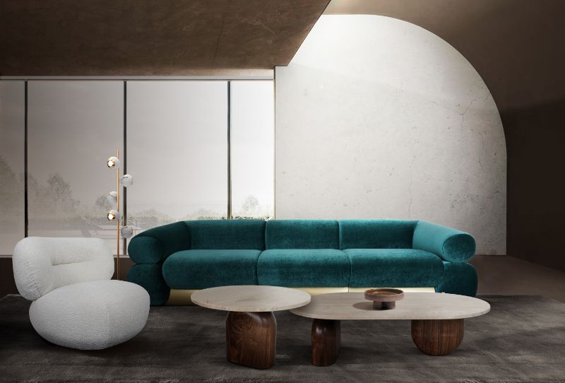 modern mid-century living room with black area rug and blue sofa and white armchair with wooden center table