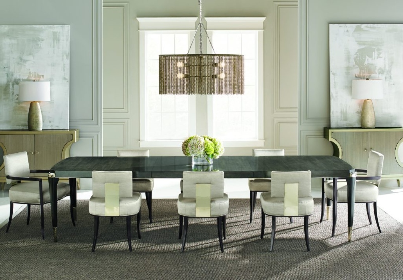 Rug Décor with Import Temptations. This modern dining room has two consoles in light brown with gold structure, a brown dining table, white armchairs and a brown rug.