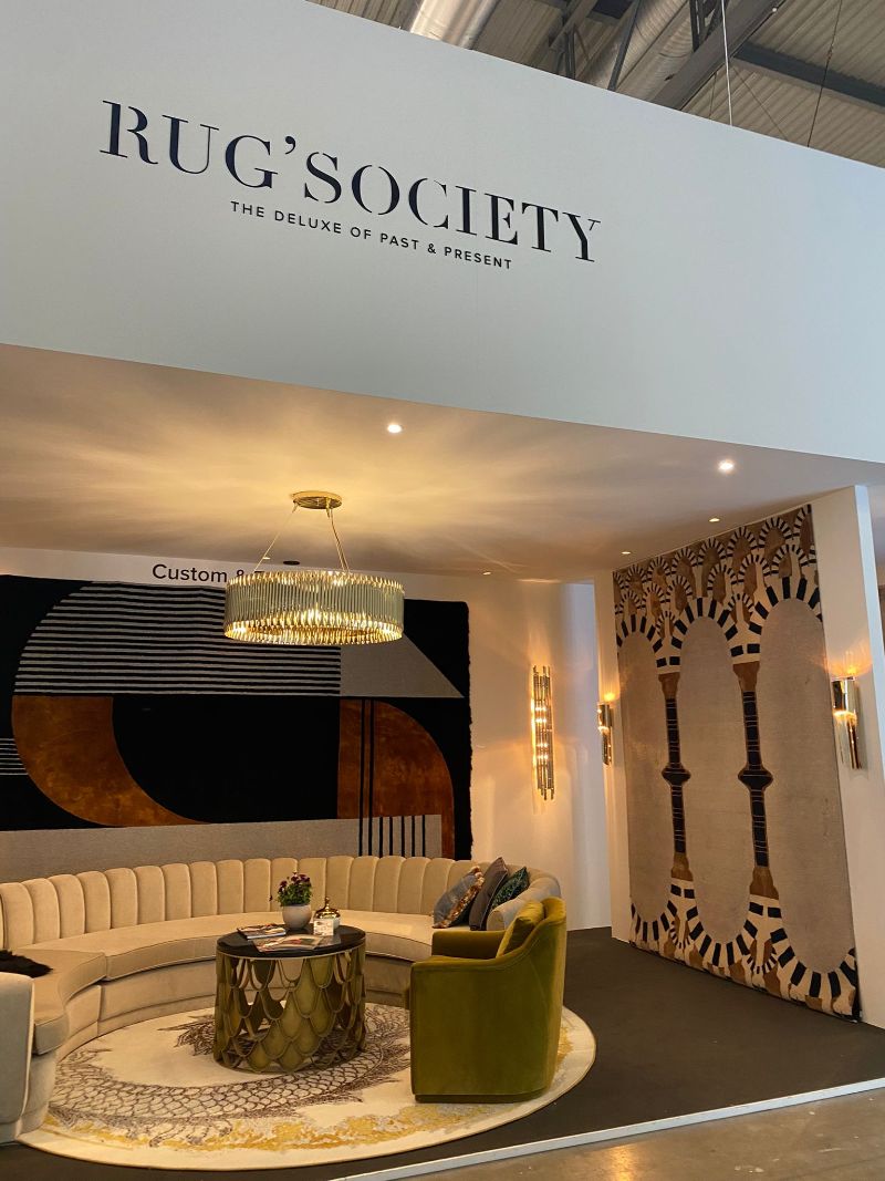 isaloni 2022: Rug'Society stand at salone del mobile in Milan 2022 with wall rugs and round rug on the floor.