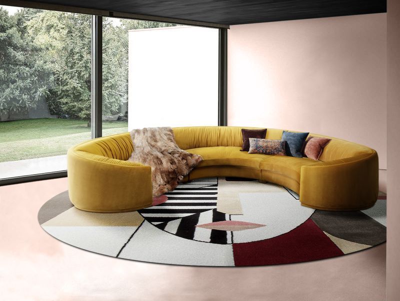 Design Guide: Style Your Interior With Contemporary Rugs. Contemporary living room decor with orange curved sofa and round geometric rug.