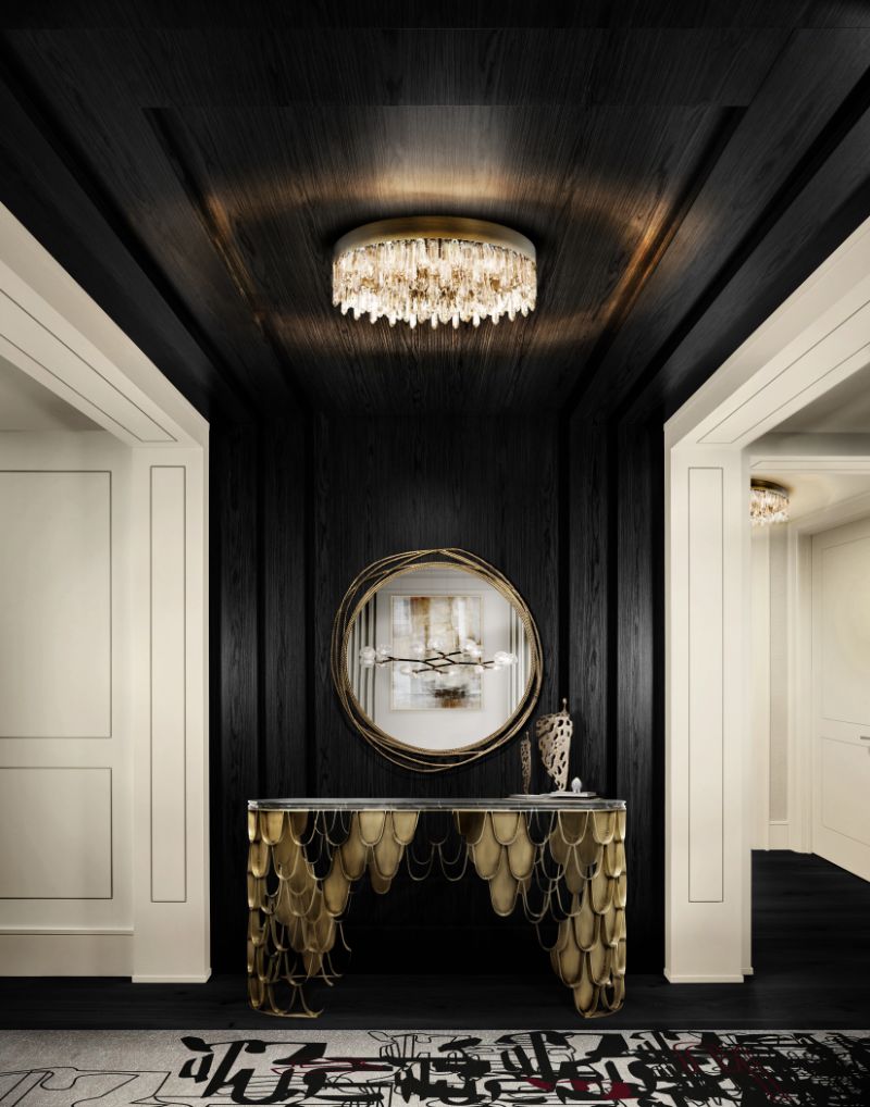 modern hallway rugs with runner rug in black and beige and a golden made of brass sideboard and mirror.