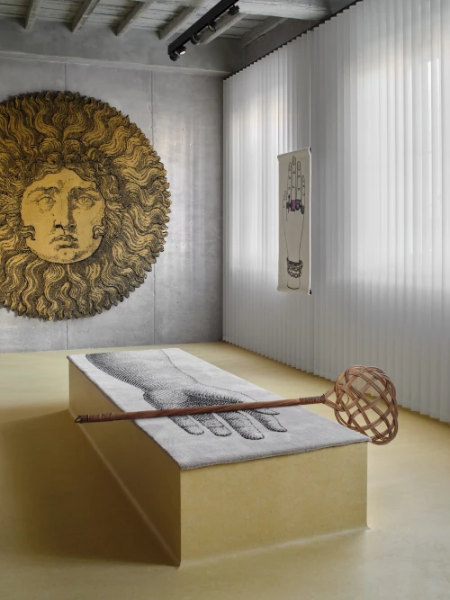Artistic Fornasetti installation featuring surreal sun and hand motifs at Milan Design Week 2026.