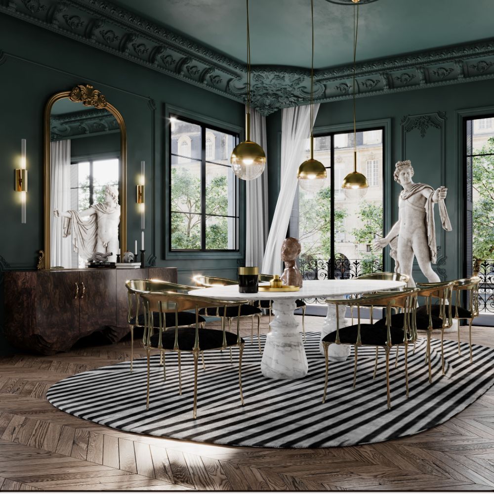 Modern classic dining room with oval black and white rug and golden dining chairs and marbled table.