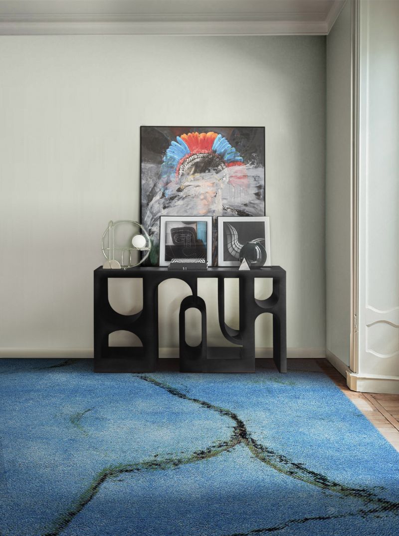 blue rug ideas for hallway with modern console and artistic portray on the wall.