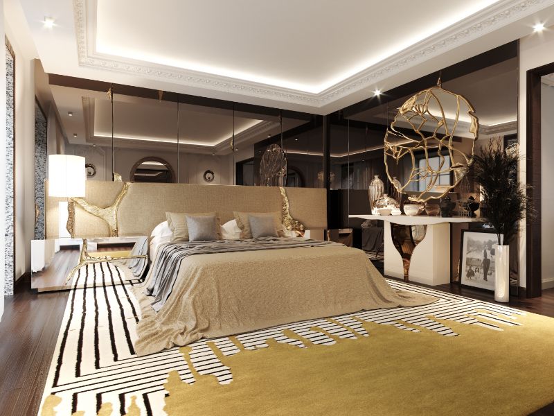 Luxurious modern contemporary bedroom decor with golden area rug and round mirror and bed frame.