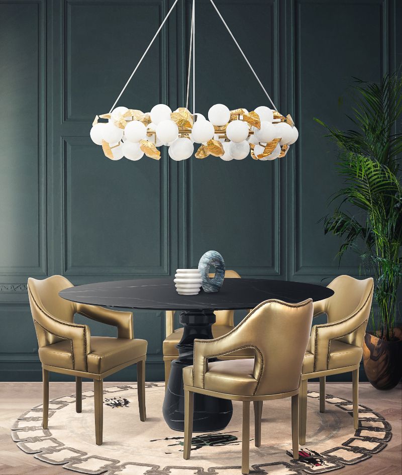 Small dining rooms can also have a luxurious vibe with the right elements. The HERA ROUND I is a gorgeous suspension light that shines upon the dark marbled round dining table. The leather dining chairs with their golden hues match the golden details of the lighting and the GOLDEN BUGS RUG adds a warming and cozy element to this room.